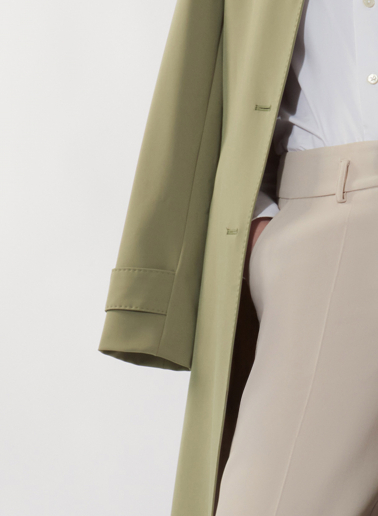 Single breasted military green trench coat in  technical fabric with hand stitches